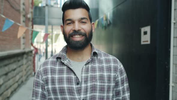 Slow Motion of Cheerful Middle Eastern Guy Making Ok Hand Gesture with Cheerful Face Standing