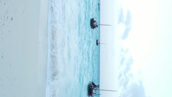 Vertical Video Boats in the Ocean Near the Coast of Zanzibar Tanzania Aerial View