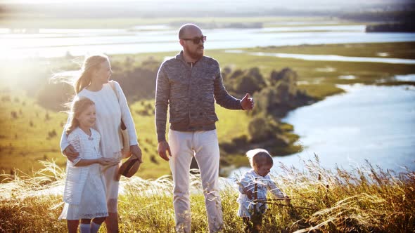 Young Family Standing on the Wheat Field - the Father Speaking