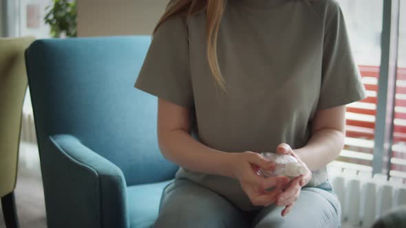 Close Up of Woman Hands Using a Hand Alcohol Gel Sanitizer Cleaning to Prevent Spread of Covid19