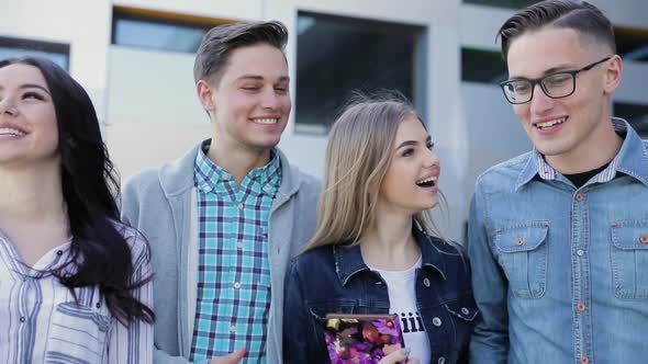 Happy Young People Walking On Street And Talking