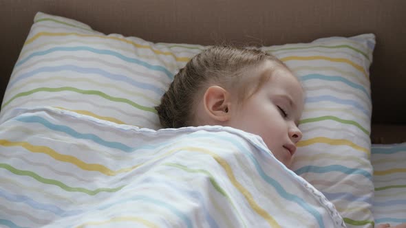 Cute Baby Napping Resting in the Nursery in His Bed