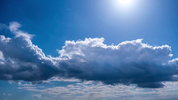 Timelapse of Cumulus Clouds Moving Under the Sun in the Blue Sky Cloud Space