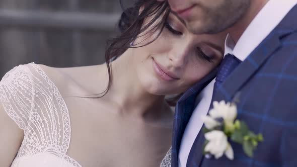 Slow Motion Close View Young Pretty Bride Leans on Husband