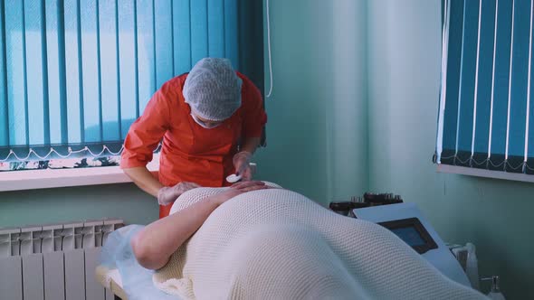 Beautician in Mask and Cap Works with Plussize Woman Face