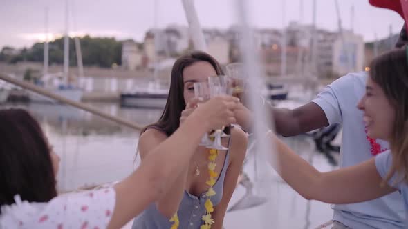 Best Friends Dancing in Yacht and Making a Toast with Champagne Celebrating Christmas at Sea