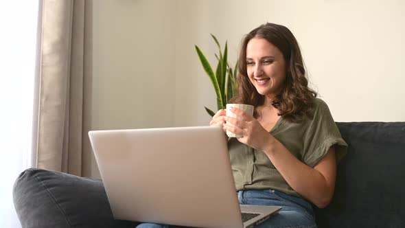 Young Freelancer Woman Takes a Break with a Cup of Coffee