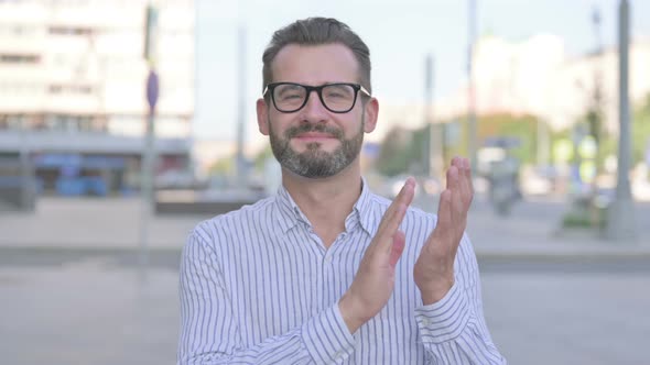 Young Adult Man Clapping in Appreciation Outdoor