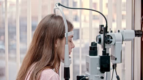 Woman  Putting Chin on Modern Vision Test Device