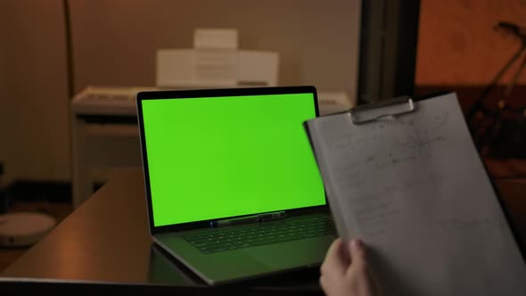 Writing Scientific Notes Behind Green Screen Laptop at Home