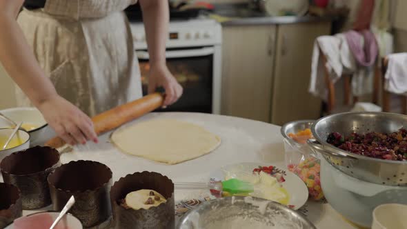 Woman Rolls Out Raw Dough with a Rolling Pin in Slowmo