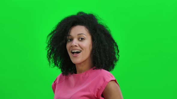 Portrait of Young Female African American Smiling Flirtatiously at the Camera and Winking