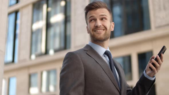 Caucasian Businessman Using His Smartphone