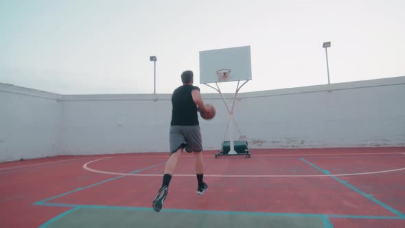 Pov tracking shot of male professional basketball player throwing ball into basket