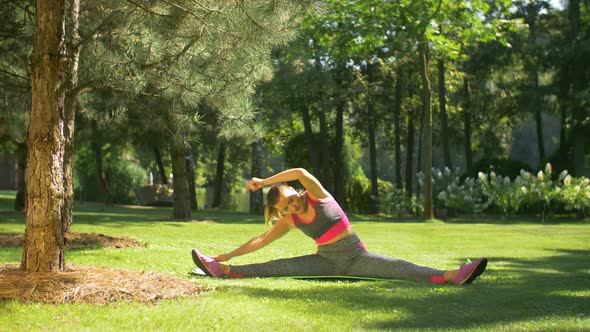 Sporty Fit Woman Exercising and Stretching Her Body