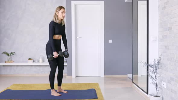 Woman Lifting Weights Dumbbells, Exercising at Home in Sportswear