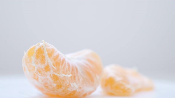 Orange fruit peeled off on white surface slow tilting 4K 2160p 30fps UltraHD video - Healthy Citrus 