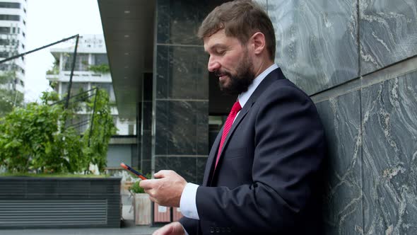 Business Man Texting Phone in the Street