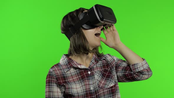 Young Girl Using VR App Helmet To Play Simulation Game. Woman Watching Virtual Reality 3d Video