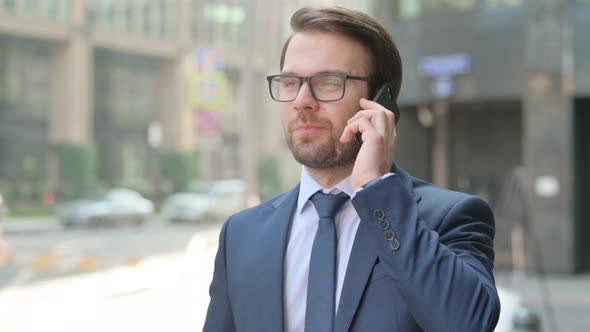 Portrait of Businessman Talking on Smartphone