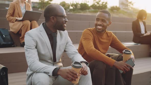 African American Businessmen Chatting over Coffee Outdoors