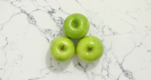 Fresh Three Green Apples Placed on White Marble Table