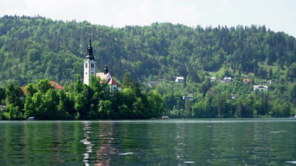 Nice hot summer day at calm Lake Bled in Slovenia with church in the middle