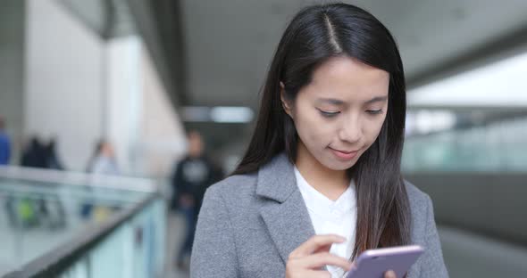 Businesswoman using looking at smart phone