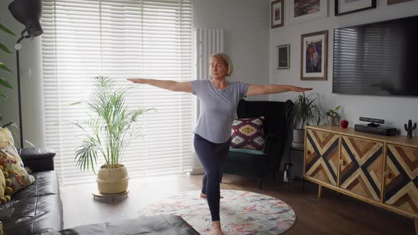 Video of active senior woman exercising at home. Shot with RED helium camera in 8K.