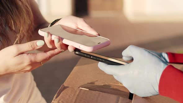 Customer Pretty Woman Paying for Lunch Box Using NFC Technology with Phone and Credit Card