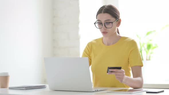 Woman making Online Payment Failure on Laptop in Office