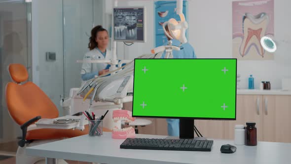 Monitor with Green Screen on Desk in Dentist Office