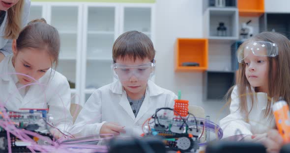 Cute Childrens Drawing Something on Paper with 3d Pen While Learning How to Use New Gadget