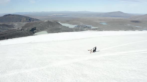 Aerial view of a snowmobile on one ski, top of the Langjokull glacier, in sunny Iceland