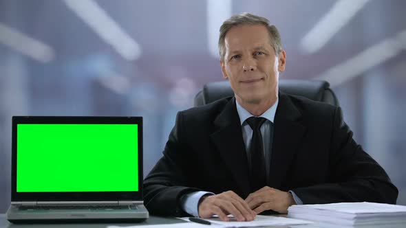 Green Screen Laptop Near Smiling Man in Suit Business Application Recommendation