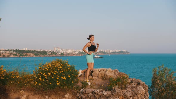 Sportive Woman Working Out on the Hill By the Sea Away From the City  Running on the Spot