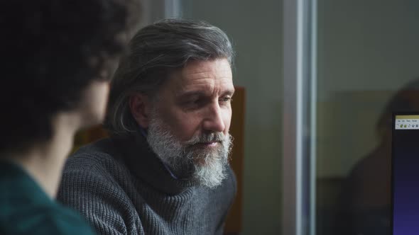 Male Coworkers Discussing Data on Computer