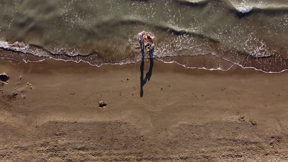 Mother and Daughter Playing on the Sandy Beach