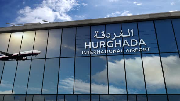 Airplane landing at Hurghada Egypt airport mirrored in terminal