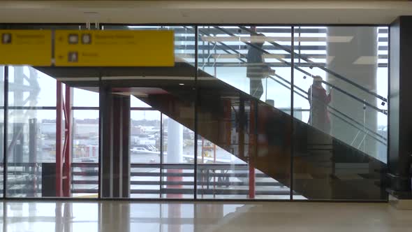 Departure Terminal Airport Hall with Escalator and Window Background