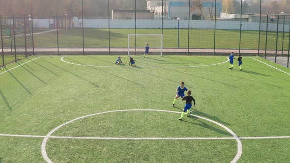 Aerial View of Young Soccer Forward Scoring Goal