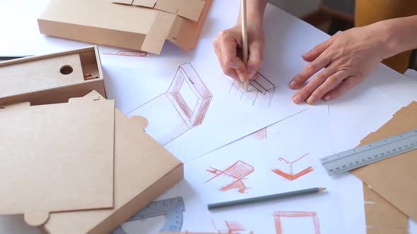 Designer draws a sketch of packaging, Creating a paper box