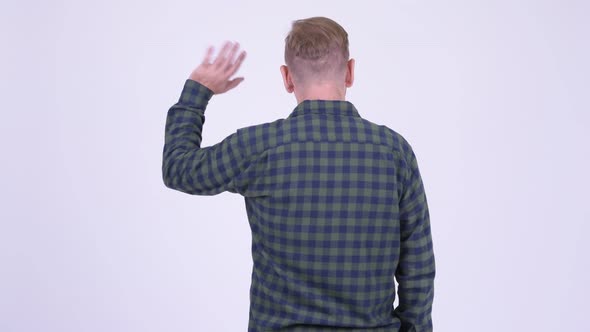 Rear View of Blonde Hipster Man Waving Hand