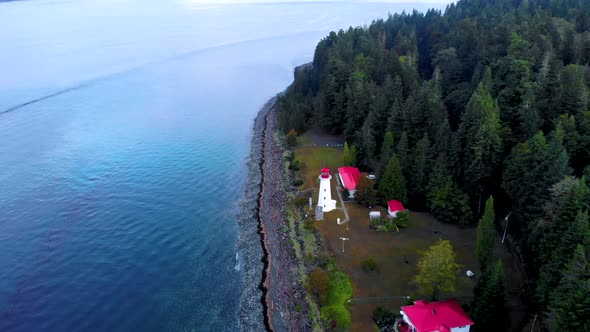 Vancouver Island Canada Quadra Island Old Historical Lighthouse at Cape Mudge Couple in Yellow Rain