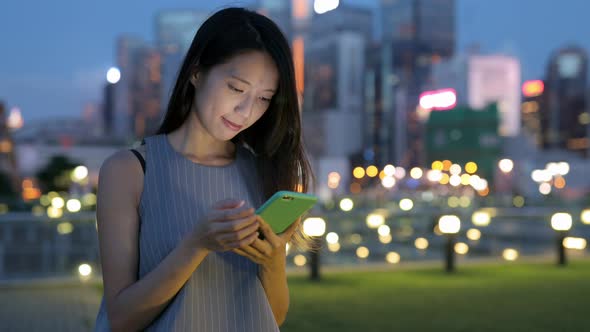 Woman use of mobile phone at night