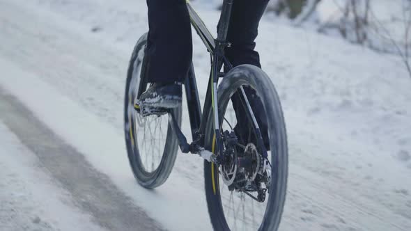 Cycling in the Winter Through a Snowy Forest