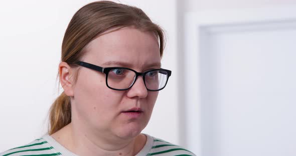 Portrait of Young Woman with Glasses Who Looks with Shock and Discouragement at Mess Turns Head and