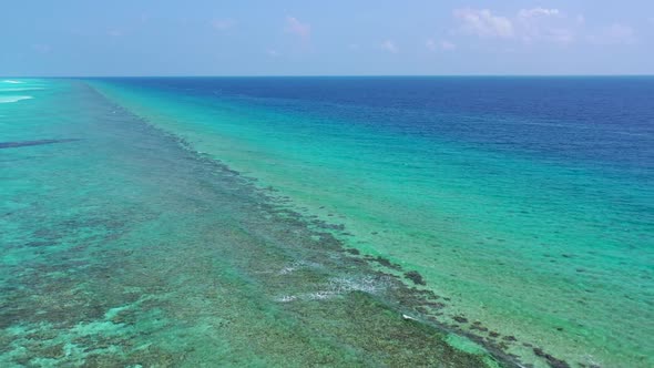 Aerial flying over texture of tropical lagoon beach holiday by blue green sea with white sand backgr