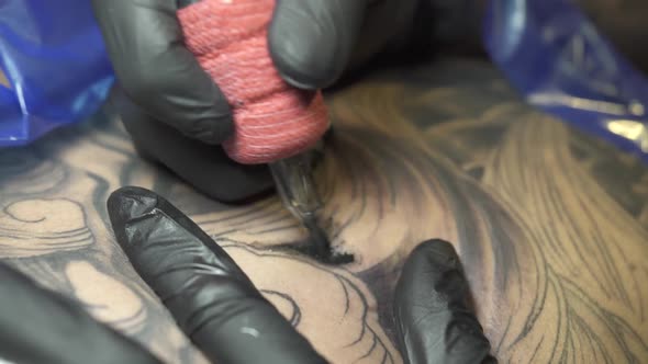 Tattoo Artist Applies Colour Person Back Needles