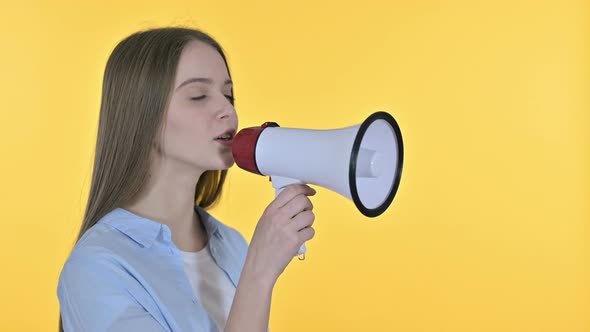 Beautiful Woman Announcing on Loudspeaker, Yellow Background